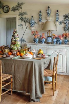 a dining room table covered in plates and bowls