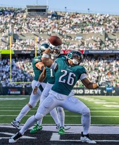 two football players are in the air during a game