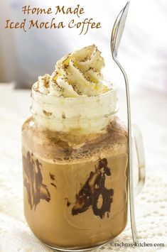 an iced mocha coffee in a glass jar with whipped cream and chocolate on top