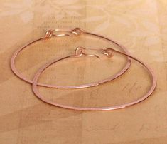 Large 14k rose gold filled hoop earrings. Rose gold filled hoops made with thick hammered wire. Each hoop earring pictured measures 2 1/4 inches wide. Earrings are handmade to order and may vary slightly from pictures. I test drive all my earring designs, they are light weight and very comfortable. Large Hoops available in 14K rose gold filled, 14k yellow gold filled, sterling silver, and smaller sizes. Availavle at BlueWaveJewelry.Etsy.Com Shop more gold filled hoops: https://www.etsy.com/shop/ Hammered Rose Gold Hoop Earrings Gift, Rose Gold Wire Wrapped Hoop Earrings, Rose Gold Hammered Small Hoop Earrings, Rose Gold Hoop Earrings, Earring Designs, Gold Filled Hoops, Test Drive, Gold Hoop, Gold Hoop Earrings