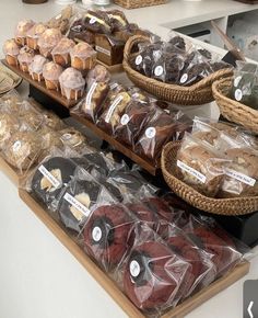 various pastries are on display in baskets and at the counter for customers to purchase