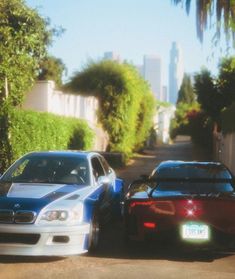 two cars parked next to each other on a street