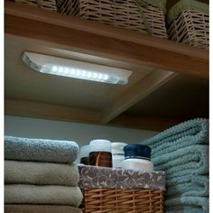 a bathroom with towels, soaps and lotion on the shelf next to it