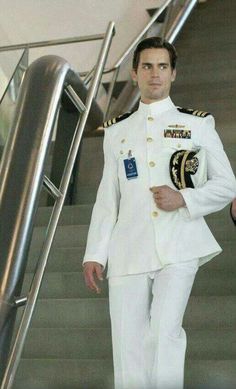 a man in uniform is walking down the stairs