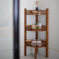 a wooden shelf with towels and soaps on it