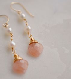 Add a subtle touch of elegance to your look with these beautiful Peach Moonstone and Freshwater Pearl dangle earrings. With their warm, peachy tones and soft pearls, these earrings feel inviting and calming and are perfect for weddings or special occasions.Peach Moonstone is known for aiding in the release of negative thinking and being overly self-critical. It's believed to be a stone of new beginnings, that brings balance and relief from emotional issues. The matching necklace is here.LENGTH: Elegant Peach Dangle Earrings, Handmade Apricot Earrings In Elegant Style, Elegant Apricot Earrings For Gift, Handmade Apricot Earrings Elegant Style, Handmade Elegant Apricot Earrings, Peach Pearl Drop Jewelry As Gift, Peach Pearl Drop Jewelry Gift, Peach Pearl Drop Jewelry For Gift, Elegant Apricot Dangle Earrings