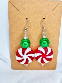 Large Christmas Peppermint Earrings  Peppermint is Acrylic  Green bead is acrylic  Small crystal bead Christmas Holiday Round Bead Earrings, Christmas Holiday Round Beaded Earrings, Holiday Green Handmade Earrings, Green Handmade Holiday Earrings, Holiday Green Handmade Beaded Earrings, Handmade Green Earrings For Holidays, Green Handmade Earrings For Holiday, Handmade Green Beaded Earrings For Holiday, Green Beaded Earrings For Holiday Gift