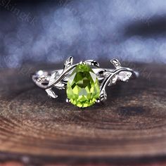 a green ring sitting on top of a wooden table