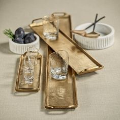 gold serving trays with glasses on them