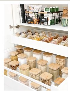 an organized pantry filled with lots of food and storage bins on the bottom shelf