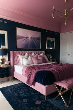 a pink and blue bedroom with a large bed