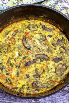 an omelet with mushrooms and carrots in a pan