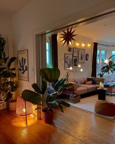 a living room filled with furniture and lots of plants