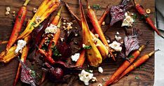 carrots, beets and goat cheese on a cutting board