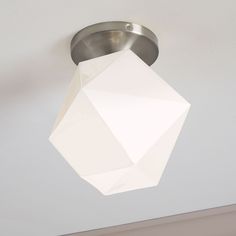 a white light fixture hanging from the ceiling