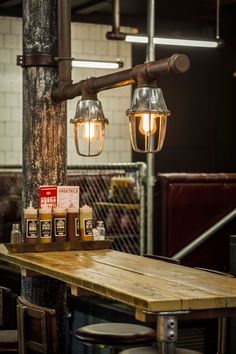 a wooden table with some lights hanging from it's sides and bottles on top