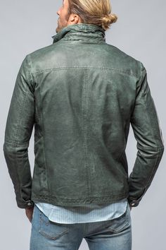 A softer take on leather; the Dino jacket from Gimo's features the same "cool-guy" attitude of its moto jacket counterparts, but shifts away from a stark, harsher aesthetic. Buttery soft lambskin that has been veg-dyed into a marine style green sets the tone, and precision craftsmanship of the four-pocket silhouette brings the style over the top. Washed, veg-dyed lambskin leather Two interior zip pockets Four patch pockets Lightweight cotton lining Runs trim- consider sizing up for a more comfor Jean Jacket Hoodie, Motorcycle Leather Jacket, Herringbone Jacket, Luxury Outerwear, Mens Fashion Wear, Men Jackets, Motorcycle Leather, Leather Motorcycle Jacket, Italian Luxury