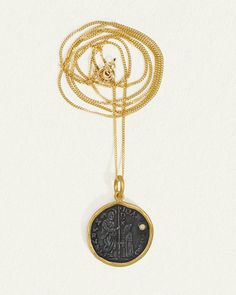 Revel in the rich history and opulent design of the Regis Necklace. Set within the warmth of 24k yellow gold is an intriguing coin of oxidised silver. Punctuated by a solitary natural diamond, this necklace depicts a coronation scene, while the reverse side shows a king and the word 'REGIS'.  
 Completing this two-toned diamond necklace is a 14k yellow gold curb chain. Elegant Coin Pendant Necklace For Ceremonial Use, Ceremonial Yellow Gold Coin Pendant Necklace, Luxury Medallion Necklace With Intaglio, Timeless Coin Shaped Engraved Necklace, Timeless Engraved Coin Necklace, Luxury Engraved Coin Necklace, Yellow Gold Byzantine Medallion Coin Necklace, Yellow Gold Byzantine Necklace With Coin Pendant, Byzantine Yellow Gold Necklace With Coin Pendant