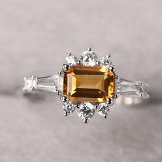 ◆ The ring is handcrafted from sterling silver and decorated with a dazzling 5*7 mm Citrine and CZs. It is suitable for engagement/anniversary/daily occasion. ◆ Production Description: Main stone Type: Natural Citrine Main Stone Shape: Emerald Cut Main Stone Size: 5*7 mm(1.01ct) Side stone: CZ Metal: 925 Sterling silver - Other options available in the drop down menu ◆ Customization: √Free for Add Engraving √Other Metal Type Available √Other Gemstones & Shapes Available √Personalization Requ Wedding Rings With Citrine In Baguette Cut, Citrine Baguette Cut Wedding Rings, Baguette Cut Citrine Wedding Rings, Elegant Citrine Diamond Ring With Accents, Elegant Citrine Crystal Ring With Birthstone, Elegant Citrine Crystal Promise Ring, Citrine Baguette Cut Ring For Anniversary, Elegant Citrine Crystal Ring With Gemstone, Elegant Citrine Birthstone Ring For Formal Occasions