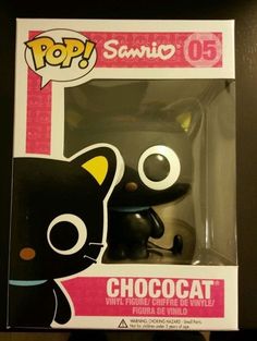 a black cat with yellow eyes is in a white box and has the word sanrio on it