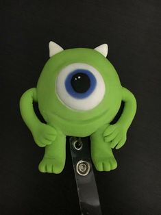 a close up of a green toy with blue eyes