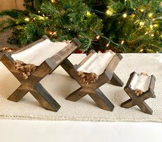 two wooden chairs sitting next to a christmas tree