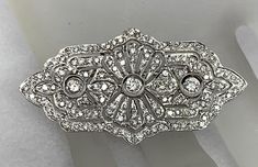 This is a Top Quality Reproduction of an Antique Brooch  It is made in 18 karat white gold and set with 2.50 carats of diamonds of various sizes and fine quality The diamonds range from F-G in color and VS-SI clarity. The workmanship on this beautiful brooch is of the finest quality. The Brooch weighs 8.1 grams Vintage White Gold Brooches With Brilliant Cut, Art Deco White Gold Platinum Brooches, Art Deco Platinum Brooches In White Gold, Art Deco White Gold Brooch In Platinum, Classic Platinum Brooch With Brilliant Cut, Classic Platinum Brooches, Vintage Brooches With Brilliant Cut Diamonds, Art Deco White Gold Diamond Brooch, Classic Platinum Brooches With Diamond Accents