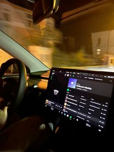 the interior of a car with dashboard, steering wheel and display screen showing information about vehicles