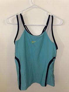 a women's nike tank top hanging on a hanger