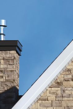 a chimney on top of a brick building with a sky in the backround