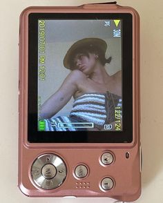 a pink cell phone sitting on top of a table