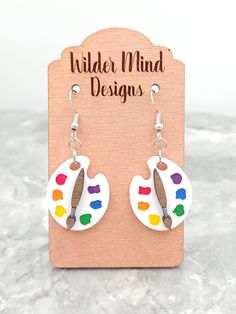 Paint Pallet Earrings. These would make a great gift for any artist, painter, crafter or art teacher! They are made with white acrylic. They are laser cut/laser engraved, hand painted with acrylic paint and are super lightweight making them easy to wear all day!  *Please Reference Size Guide Picture for sizing* Ear wires are made from surgical stainless steel. Since these earrings are handmade, I highly recommend taking them off for any water related activities such as swimming or showering and Paint Earrings, Artsy Hand Painted Earrings For Everyday, Painting Earrings, Artistic Hand Painted Earrings For Gifts, Art Teacher Earrings, Painters Palette Earrings, Painter Gifts, Playful Hand-painted Dangle Earrings, Laser Cut Necklace