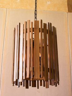 a wooden light fixture hanging from a ceiling