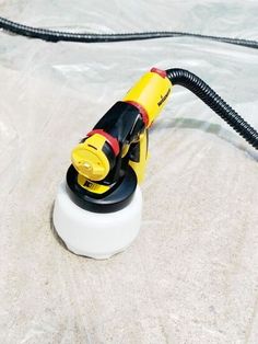 a yellow and black blow dryer sitting on top of a plastic bag