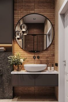 a bathroom with a large round mirror above the sink