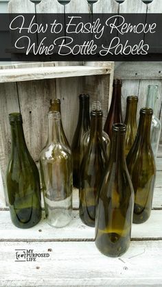 several empty wine bottles sitting on top of a wooden crate with the words how to easily remove wine bottle labels