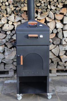 a black stove sitting next to a pile of logs