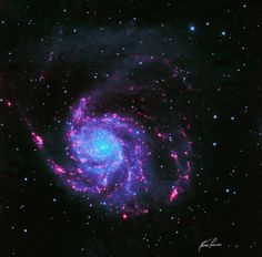 an image of a spiral galaxy in the night sky with stars around it and blue, pink and purple colors