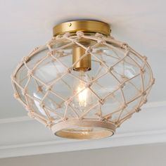 a light that is hanging from the ceiling in a room with a rope around it