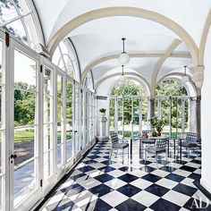 an elegant dining room with large windows and checkered flooring