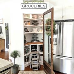 an open pantry in the corner of a kitchen