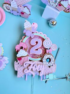 a birthday cake with the number twenty two on it is surrounded by cupcakes