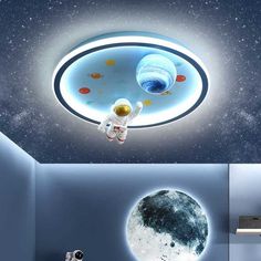 an astronaut floating in the sky next to a moon and stars ceiling light with lights on it