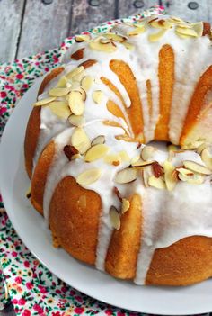 a bundt cake with white frosting and almonds