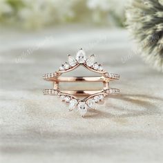 a close up of a ring on a table with some flowers in the back ground