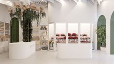 the interior of a flower shop with white walls