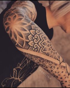 a woman with tattoos on her arm and leg