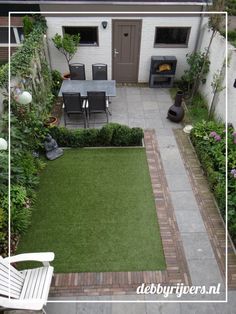 an aerial view of a small backyard with lawn and patio furniture in the back yard