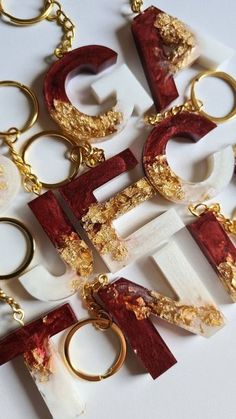 several pieces of gold and red jewelry on a white surface