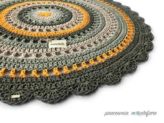 a crocheted placemat with yellow and gray circles